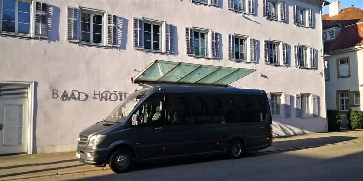Van for soloist transfers in front of a hotel